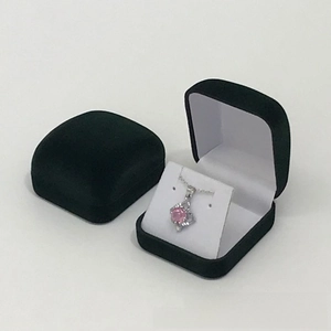 Detail of two black velvet jewelry boxes with open view showing a pink stone necklace
