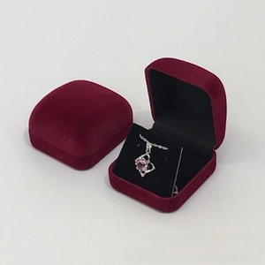 Detail view of red velvet necklace gift box with black lining and silver heart pendant