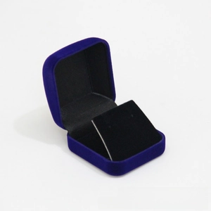Detail of a dark blue velvet jewelry box for rings with black flocked interior lining
