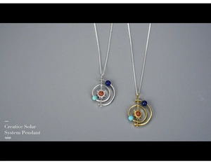 Detailed view of Creative Solar System Pendants in gold and silver with colorful planet beads