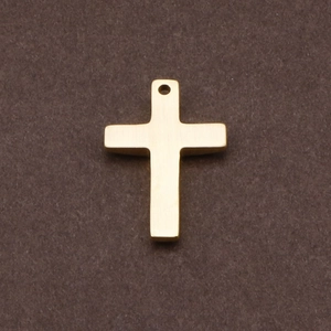 Minimalist golden cross pendant with smooth metal finish on a textured background