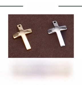 Polished stainless steel cross pendant detail with weight specification and side hole