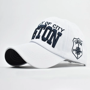 Detailed view of deep blue 3D letter embroidery on a white cotton baseball cap
