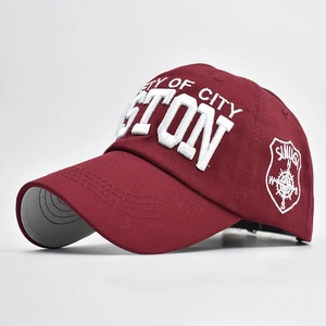 Close-up of 3D embroidery detail and side shield patch on burgundy baseball cap
