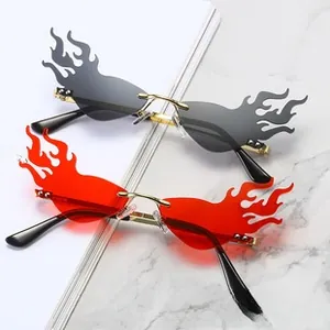 Detail of flame-shaped rimless sunglasses with gold bridge and grey lenses