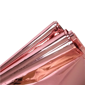 Detailed macro view of the shiny rose gold foil texture on a party tablecloth roll