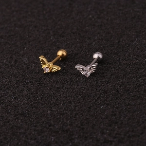 Macro view of insect-shaped crown stud earrings with clear round stones and screw backs