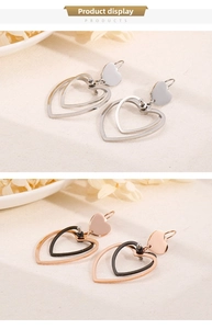 Detailed view of double heart dangle earrings in silver and rose gold finishes