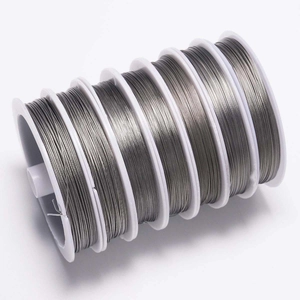 Detailed view of six rolls of silver steel wire for DIY jewelry making and beading