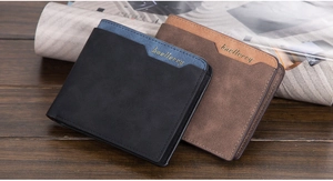 Close-up of minimalist bi-fold wallets in black and brown matte leather on wood