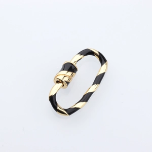 Macro detail of oval gold and black enamel spiral screw clasp for DIY jewelry making