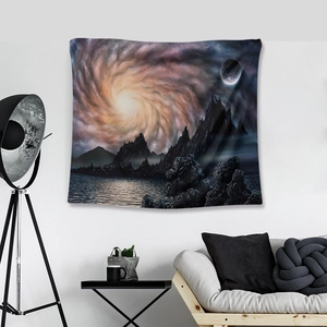 Modern wall tapestry with galaxy mountains and moon scene hung in a stylish living room