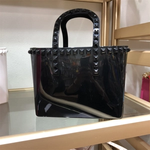 Black jelly tote bag with studded trim and large capacity PVC bucket design for women