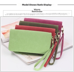 Macro view of four matte suede leather wallets with wrist straps and gold metal hooks