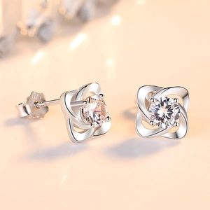 Exquisite S999 sterling silver four-leaf clover stud earrings with sparkling center stone