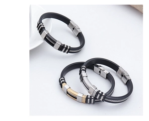 Detail of minimalist silicone and stainless steel bracelets in gold and black finish