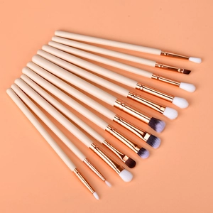 12-piece rose gold eye makeup brush set with synthetic bristles in a fan-shaped display