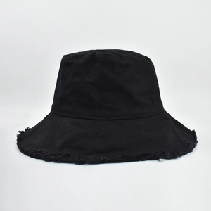 Detail of black canvas bucket hat with raw frayed edges and retro distressed style