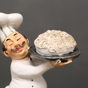 Vintage chef resin statue holding a plate of noodles for kitchen and dining room decor