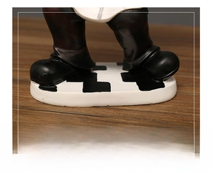 Detail of stable anti-scratch chef figurine base on wooden surface with checkered pattern