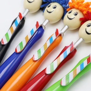 Detail of five-color cartoon doll ballpoint pens with colorful fluffy fiber hair and tie clips