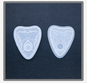 Macro detail of planchette silicone mold with butterfly relief for resin crafting