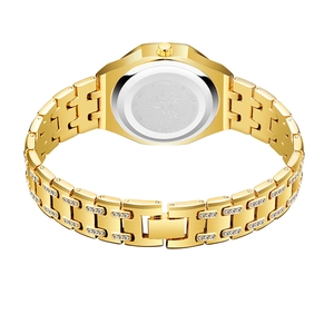 Detailed close-up of the golden watch band with sparkling crystals and folding clasp