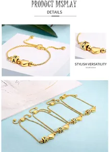 Close-up of adjustable gold heart bracelet with custom letter charm cubes and slider