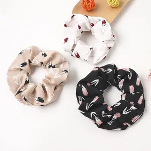 Three-piece floral scrunchies set with tulip patterns in white, beige, and black