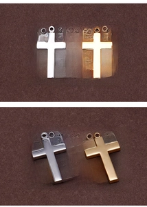Detailed view of polished gold and silver religious cross pendants in stainless steel