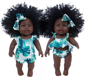 Detail of 12-inch African baby dolls with afro hair and palm leaf pattern outfits