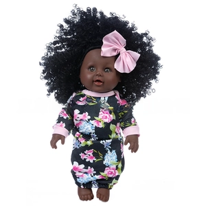 Close-up of a black baby doll with curly afro hair wearing floral romper and pink bow