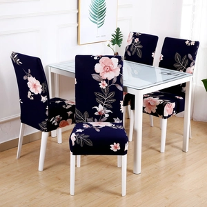 Dining chair covers with dark blue floral print on four chairs in a modern home setting