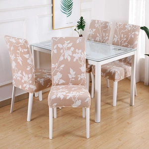 Elastic chair covers with white floral patterns on beige fabric for dining room chairs