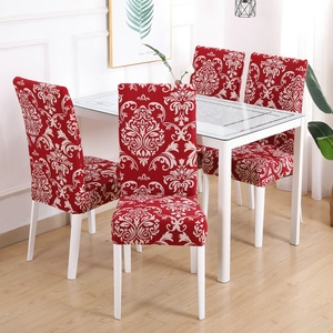 Detail of red damask pattern elastic chair cover on a modern dining chair in a room
