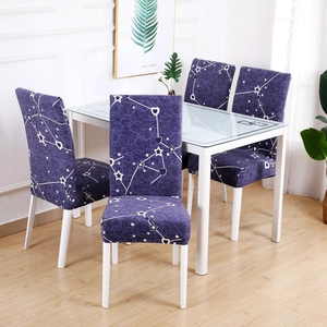 Dining room scene showing four stretchable dark purple chair covers with white star patterns