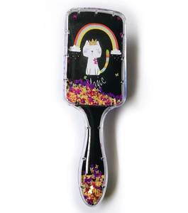 Detail of magic cat hairbrush showing flowing glitter and colorful sequins inside