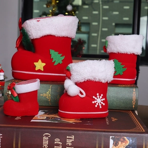 Detail of red flocked Christmas candy boots in four sizes with festive holiday patterns