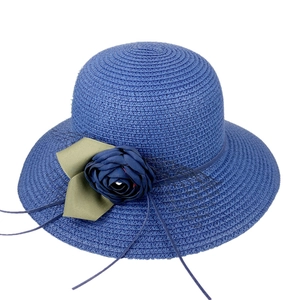 Blue straw sun hat for women featuring deep blue floral accents and green ribbon