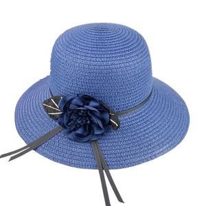 Women's dark blue wide brim straw sun hat with flower accent and elegant ribbons
