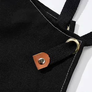 Black cotton canvas barista apron with reinforced stitching and leather trim details