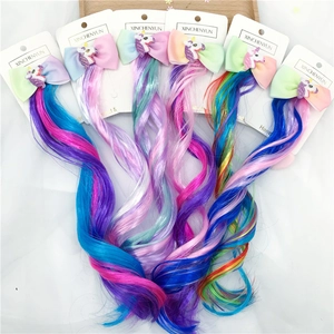 Set of six colorful unicorn bow hair clips with glitter accents and long gradient hair pieces