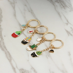 Detailed macro of zinc alloy succulent plant keychains with colorful enamel pots