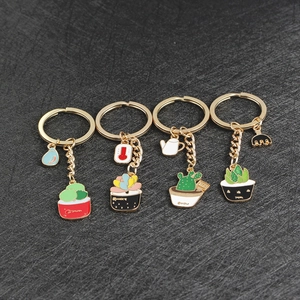 Detail showing set of four zinc alloy succulent and cactus keychains with drip oil finish