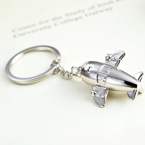 Macro shot of silver metal J-20 fighter jet keychain with detailed polished surface