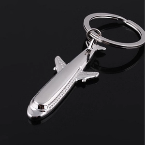 Sleek silver metal J-20 fighter jet airplane keychain on a minimalist black background