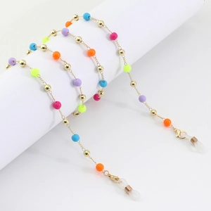 Detail of colorful acrylic beads and golden metal spheres on a multi-use eyewear chain