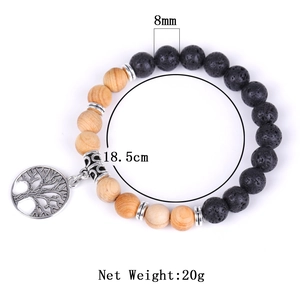 Detailed view of 8mm wood and lava stone beads with a silver Tree of Life charm