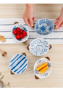 Top view of ceramic dipping bowls with double handles in various hand-painted patterns