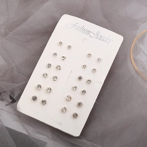Close-up of 12-pair stud earring set with zircon stones on white display card